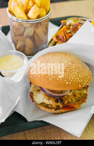 Fast food. Hamburger and French fries in restaurant. Stock Photo