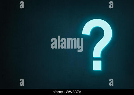 Neon question mark glows on a dark background, the concept of finding the answer to a question or finding a solution. Stock Photo