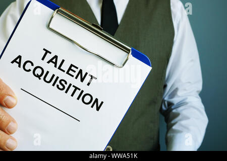 Man is holding sign talent acquisition strategy. Stock Photo