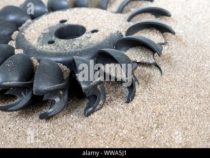 Old water turbine on dried sand with out water, useless in drought condition Stock Photo