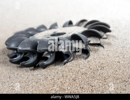 Old water turbine on dried sand with out water, useless in drought condition Stock Photo