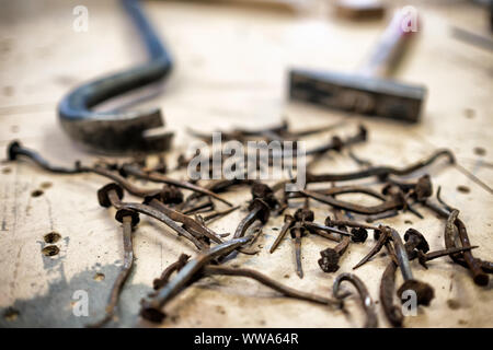 Rusty used broken nails close up view with tools on background Stock Photo