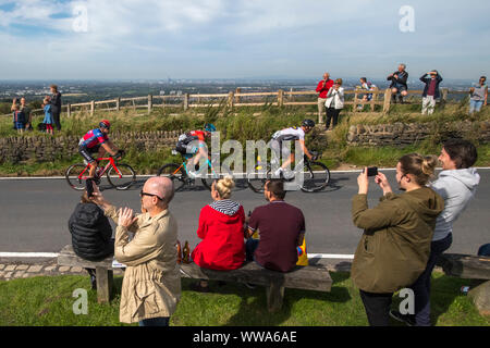 The city of Manchester is seen in the distance as the leaders of the hill climb cycle across the top of Werneth Low Country Park during stage eight of the OVO Energy Tour of Britain from Altrincham to Manchester. Stock Photo