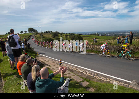 Competitors cycle across the top of Werneth Low Country Park during stage eight of the OVO Energy Tour of Britain from Altrincham to Manchester. Stock Photo