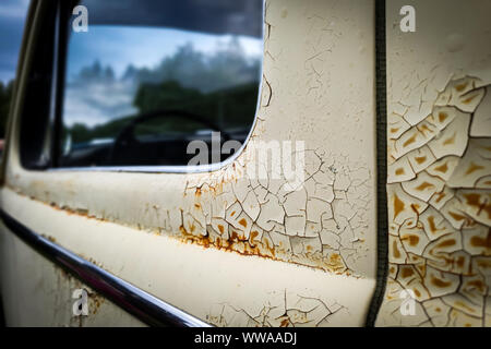 Old rusty wrecked car. Close up of cracked and peeling paint. Stock Photo