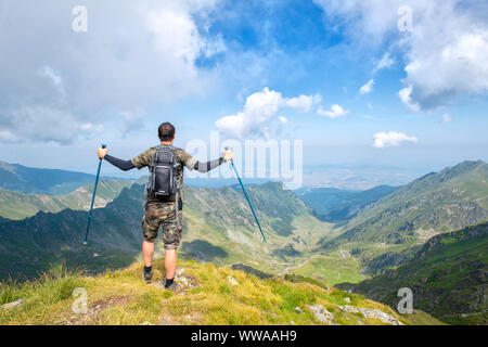 Successful active man hiker on top of mountain enjoying the view. Travel sport lifestyle concept Stock Photo