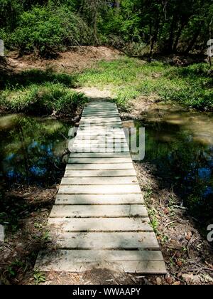 The Woodlands TX USA - 03-26-2019  -  Wooden Bridge Over a Creek 2 Stock Photo