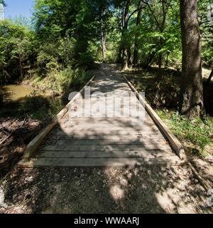 The Woodlands TX USA - 03-26-2019  -  Wooden Bridge Over a Creek Stock Photo