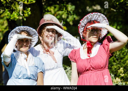 Bath, Somerset, UK. 14 Sep, 2019. Jane Austen fans taking part in the world famous Grand Regency Costumed Promenade are pictured in Bath’s Parade Gardens. The Promenade, part of the 10 day Jane Austen Festival is a procession through the streets of Bath and the participants who come from all over the world dress in 18th Century costume. Credit:  Lynchpics/Alamy Live News Stock Photo
