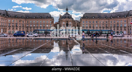 Bordeaux, France - June 27, 2015: The Water Mirror and the Stock Exchange Square on a normal afternoon in the summer. Stock Photo