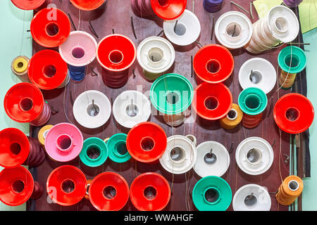 Spools of colorful thread in a sewing workshop Stock Photo
