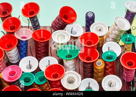 Spools of colorful thread in a sewing workshop Stock Photo