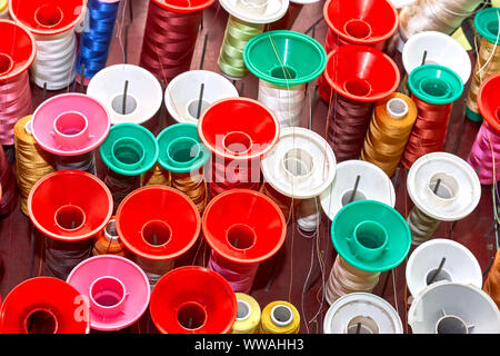 Spools of colorful thread in a sewing workshop Stock Photo