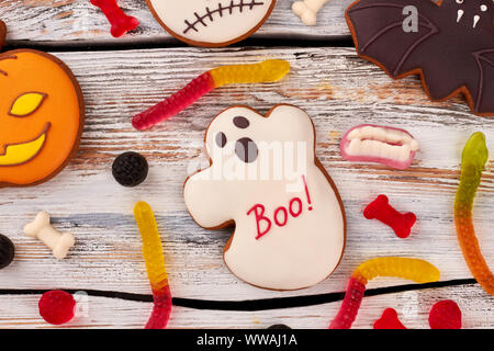 Halloween cookies and candies on wooden background. Stock Photo