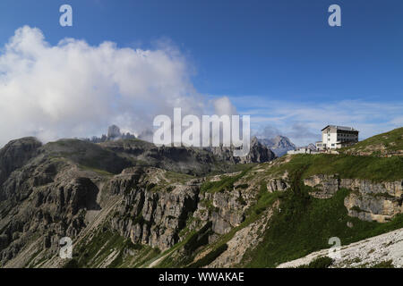 Auronzo alpine hut near the Three Peaks of Lavaredo, in the back Monte Campedelle and Col de le Bisse, Sexten Dolomites Stock Photo
