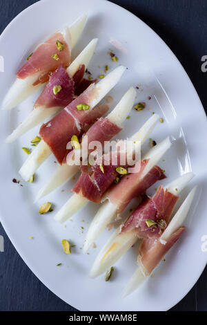 Still life with fresh melon, jamon and red wine on the table. Photo in ...
