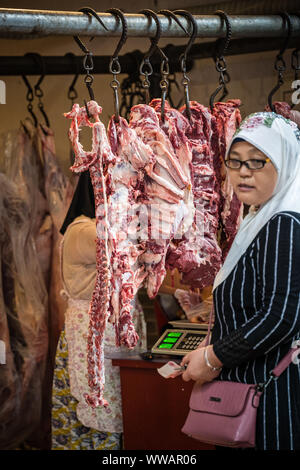 Lamb hanging from meat hooks at a wholesale butcher Stock Photo - Alamy