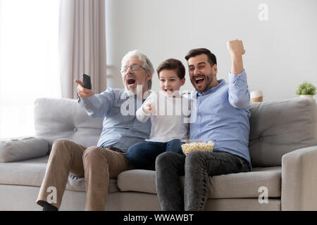 Victory. Excited, Happy Family Watching American Football Match,  Championship On The Couch At Home. Fans Emotional Cheering For Favourite  National Team. Daughter, Dad And Grandpa. Sport, TV, Having Fun. Stock  Photo, Picture