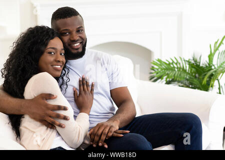Married couple sitting at home posing to camera Stock Photo