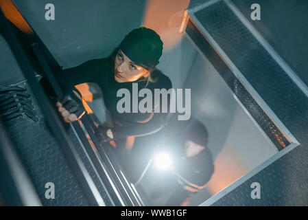 Robbers in uniform make their way into the vault Stock Photo