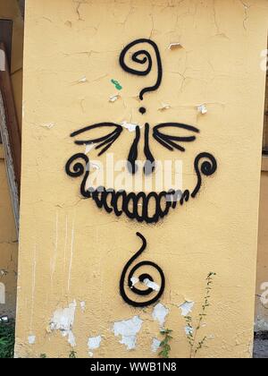 Graffiti skull face adorns an old wall Stock Photo