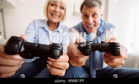 Joyful senior couple playing video games together Stock Photo