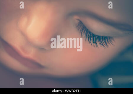 Closeup portrait of an adorable newborn child sleeping at home, face part, cute baby face, new life concept Stock Photo