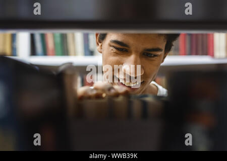 Portrait of black guy looking for interesing book Stock Photo