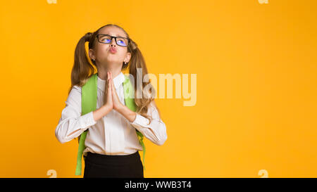 Elementary Student Girl Asking For Something Praying In Studio Stock Photo