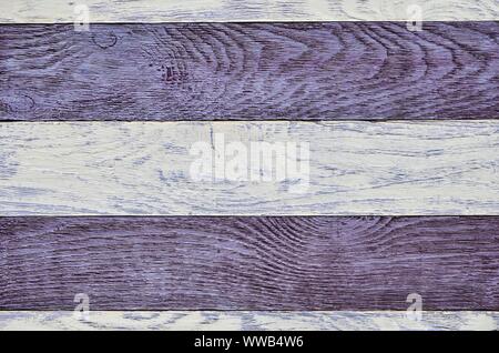 Wooden background texture. Creatively painted white and purple boards. Stock Photo