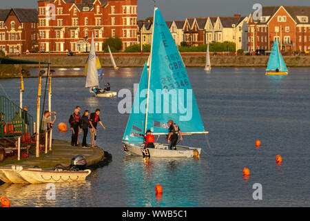 Merseyside, UK. 14th Sep, 2019. Dusk looms for competitors in the Southport 24 Hour Race. A national sailing endurance race for two-handed sailing dinghies, with up to 70 Firefly, Lark, Enterprise and GP 14 boat crews competing. The exhausting race, which is hosted by the West Lancs Yacht Club starts at 12 noon on the Saturday with the contestants racing their dinghies non-stop, around the resorts marine lake finishing at noon 24 hours later. Sailing skills and endurance are put to a severe test during the 12 hours of darkness. Credit: MediaWorldImages/Alamy Live News Stock Photo