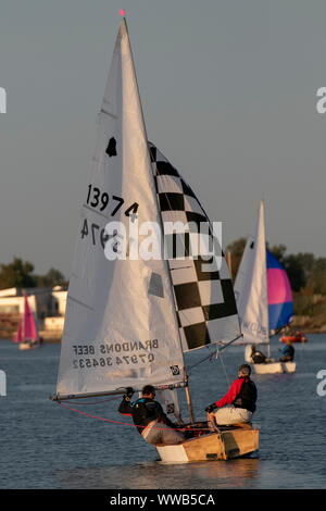 GP 14-foot dinghy raced, cruised, rowed in Merseyside, UK. Dusk looms for competitors in the Southport 24 Hour Race. A national sailing endurance race for two-handed sailing dinghies, with up to 70 Firefly, Lark, Enterprise and GP 14 boat crews competing. The exhausting race, which is hosted by the West Lancs Yacht Club starts at 12 noon on the Saturday with the contestants racing their dinghies non-stop, around the resorts marine lake finishing at noon 24 hours later. Sailing skills and endurance are put to a severe test during the 12 hours of darkness. Stock Photo
