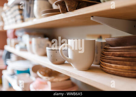 Kitchen utensils on shelf in pottery workshop Stock Photo