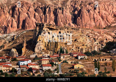 CAPPADOCIA, TURKEY. View of the village and the old troglodyte settlement of Cavusin, where you can see the oldest rock cut church in the region. Stock Photo