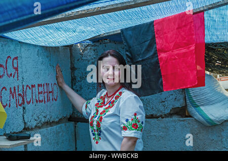 Dnipro, Ukraine - May 25, 2016: Woman in national Ukrainian embroidered shirt is in museum copy of the military refuge of concrete Stock Photo