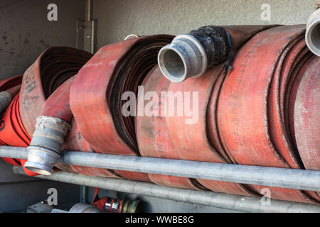 fire hoses coiled in a fire engine Stock Photo