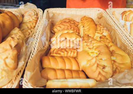Assortment of sweet pastries on the cafe counter, bread roll with poppy seeds, cinnamon and raisins Stock Photo