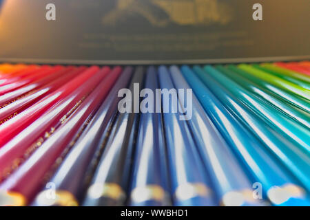 Fine art colouring pencils neatly packed all in a row in a tin case. Stock Photo