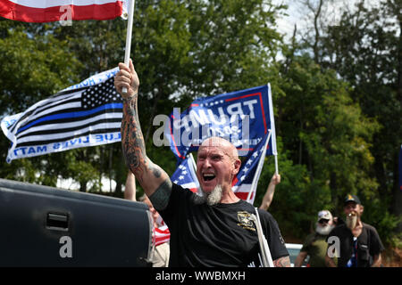 Dahlonega, Georgia, USA. 14th Sep, 2019. CHESTER DOLES, a longtime white nationalist leader, leads followers in chants of 'America is great,'' as he begins what he described as an 'American Patriot Rally'' to honor President Trump in Dahlonega, Georgia on Saturday. All told, around 50 people joined Doles' rally, while around 100 people joined counter-protests at the event, which drew 600 law enforcement officers from surrounding counties. Credit: Miguel Juarez Lugo/ZUMA Wire/Alamy Live News Stock Photo