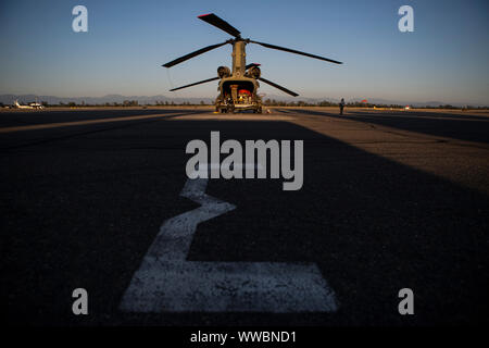 A U.S. Army CH-47 Chinook helicopter from the California Army National Guard's Bravo Company, 1st Battalion, 126th Aviation Regiment, is inspected after landing at Redding Municipal Airport, Sept. 8, 2019, in Redding, California, during the Red Bank Fire in Tehama County. Six Cal Guard helicopters were activated to assist state and federal agencies battling a pair of wildfires in the county. (U.S. Air National Guard photo by Staff Sgt. Crystal Housman) Stock Photo