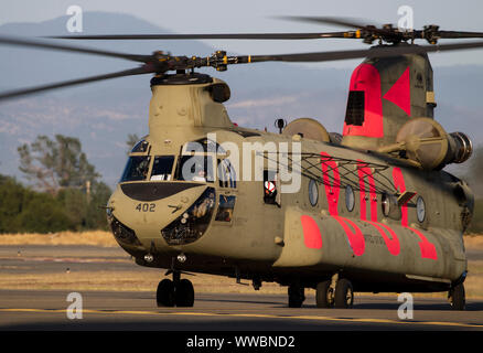 A U.S. Army CH-47 Chinook helicopter from the California Army National Guard's Bravo Company, 1st Battalion, 126th Aviation Regiment, lands at Redding Municipal Airport, Sept. 8, 2019, in Redding, California, after working the Red Bank Fire burning in Tehama County. Six Cal Guard helicopters were activated to assist state and federal agencies battling a pair of wildfires in the county. (U.S. Air National Guard photo by Staff Sgt. Crystal Housman) Stock Photo