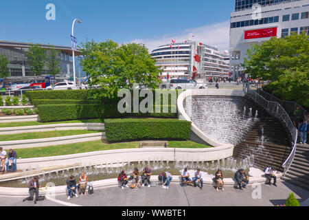 Water Fountain at 'Waterfront Centre' at Canada Place With Cruise Ship in Background, Vancouver, B. C., Canada. June 15, 2019 Stock Photo