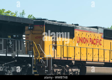 Atlanta, USA - April 20, 2018: Union Pacific locomotive cargo freight train with cars passing on railroad tracks in Georgia downtown midtown city in s Stock Photo