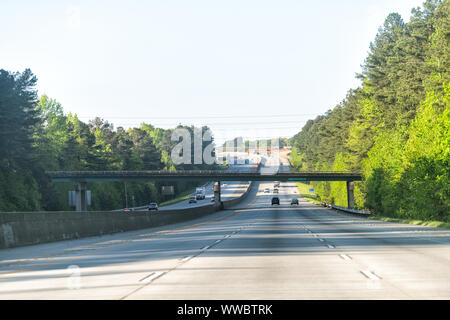 Interstate highway 85 road with overpass bridge exit sign road in early morning at city of Atlanta, Georgia with cars driving on commute Stock Photo