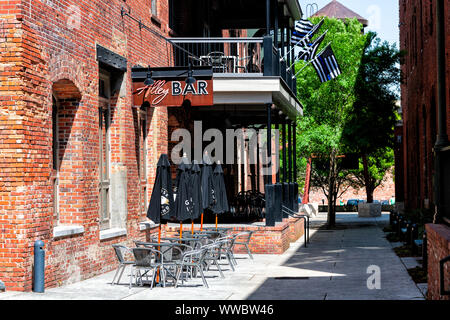 Montgomery, USA - April 21, 2018: Brick buildings restaurant bar on Alley street during day in capital Alabama city in downtown center of old town Stock Photo