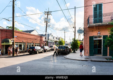 New Orleans, USA - April 22, 2018: Frenchmen street in Louisiana city, corner building with people walking by Marigny brasserie and Royal hotel bar, r Stock Photo
