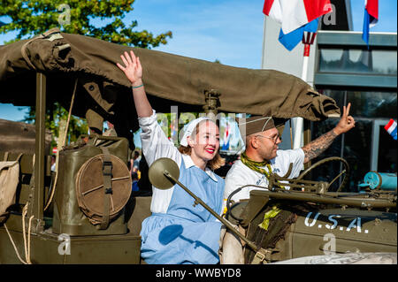 Veghel, Netherlands. 14th Sep, 2019. A man and woman are seen in a military car.The 2019, commemorating 75 years since Operation Market Garden took place. Operation Market Garden was one of the largest Allied operations of the Second World War. It took place on September 1944. At the time, the Allied Forces travelled from Belgium through several locations in the Netherlands, to finally end up in Nijmegen and Arnhem.  Netherlands. Credit: SOPA Images Limited/Alamy Live News Stock Photo