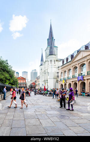 New Orleans, USA - April 22, 2018: Old town chartres street in Louisiana famous city with many people crowd at Jackson square and St Louis cathedral c Stock Photo