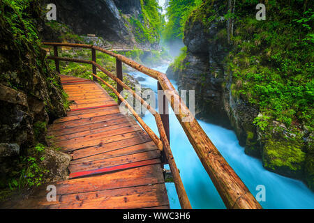Admirable and well known touristic attraction near Bled. Amazing Vintgar gorge with wooden footbridge and rumble emerald color Radovna river, near Ble Stock Photo