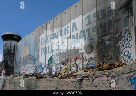 A largo graffito with the words Gernika 1936 – Palestina 1948 painted on the separation barrier or wall in Aida also spelled 'Ayda, a Palestinian refugee camp situated 2 kilometers north of Bethlehem in the central West Bank established in 1950 by refugees from the Jerusalem and Hebron areas. Palestinian Territories, Israel Stock Photo